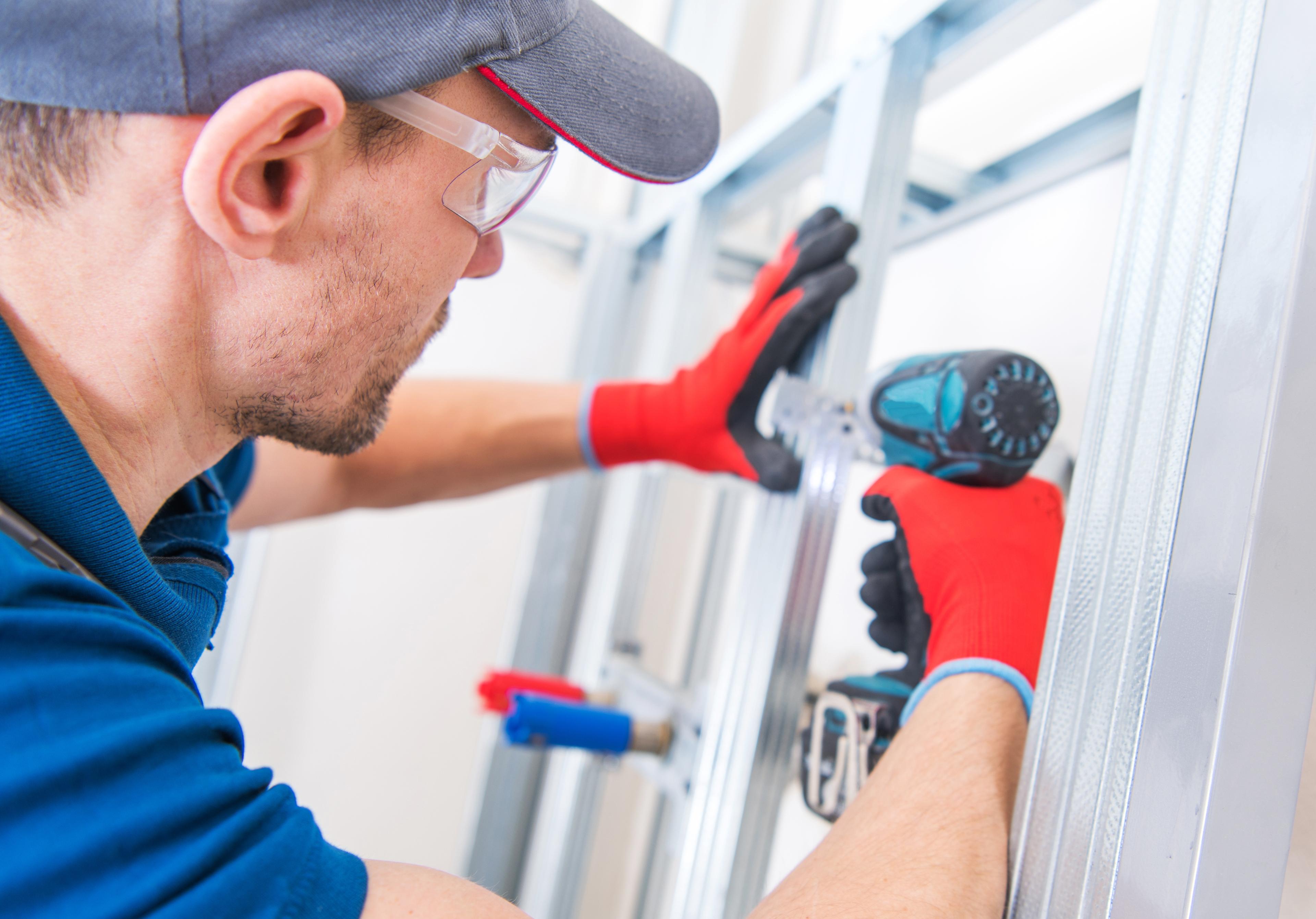 Technician building a residential garage wall